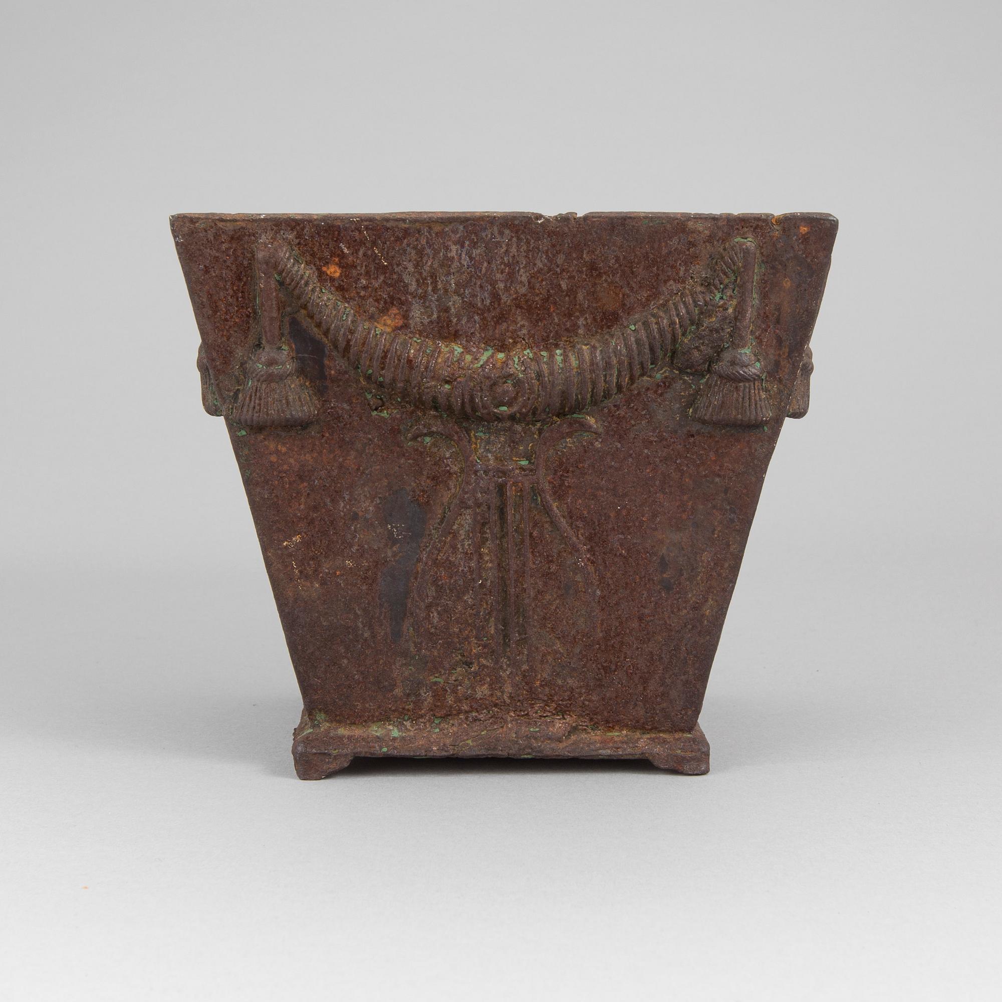 An early 19th century flower pot of cast iron.