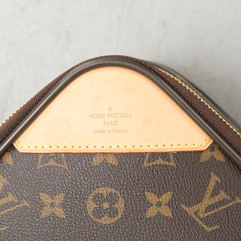 A Monogram Canvas Pégase 65 Suitcase with a Protective Cover.