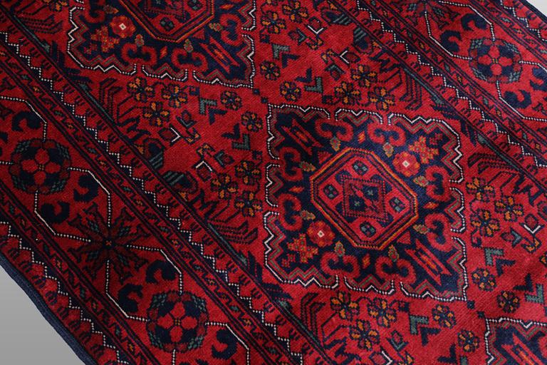 A Afghan runner carpet, 388 x 79 cm.