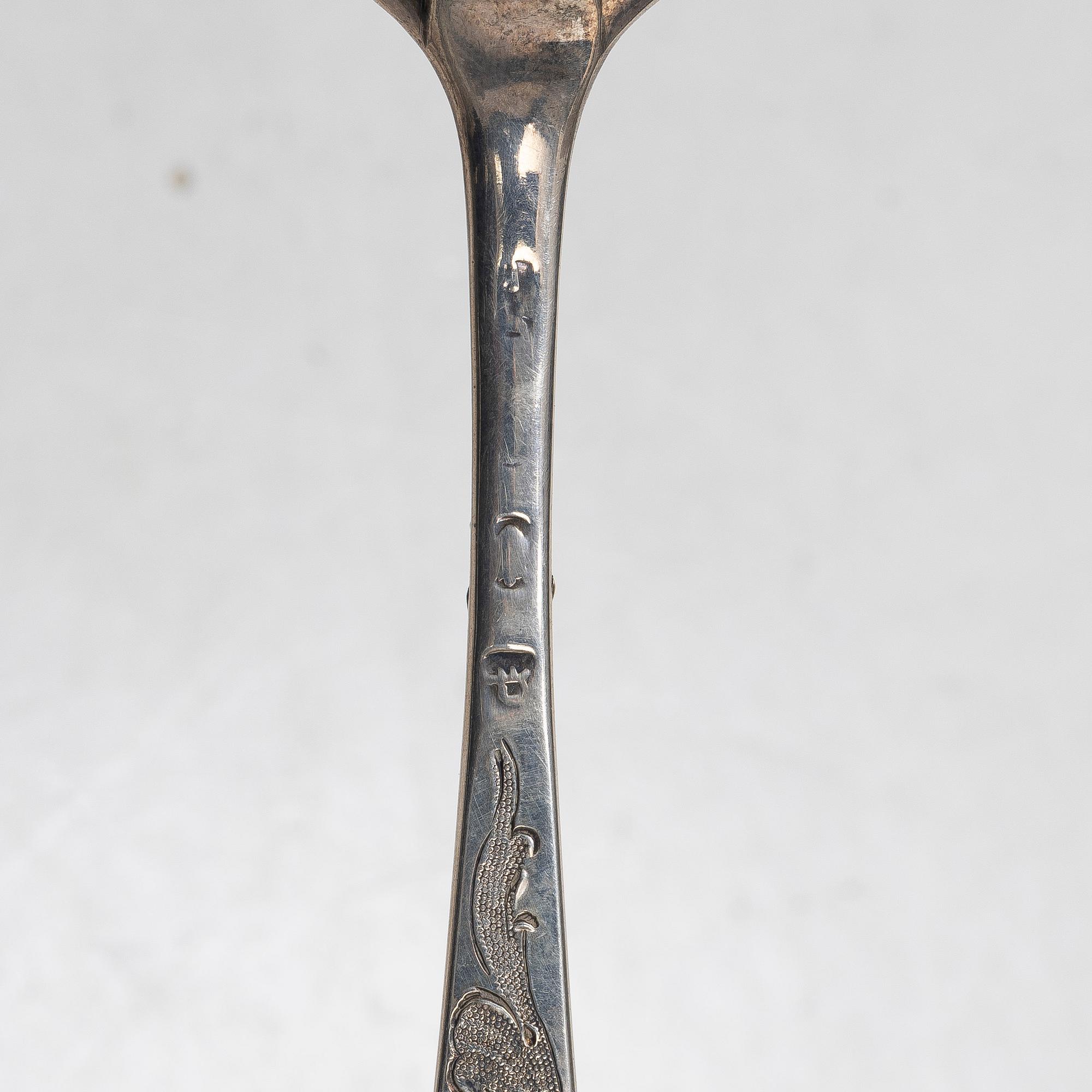 Seven silver spoons, including English and Swedish hallmarks.