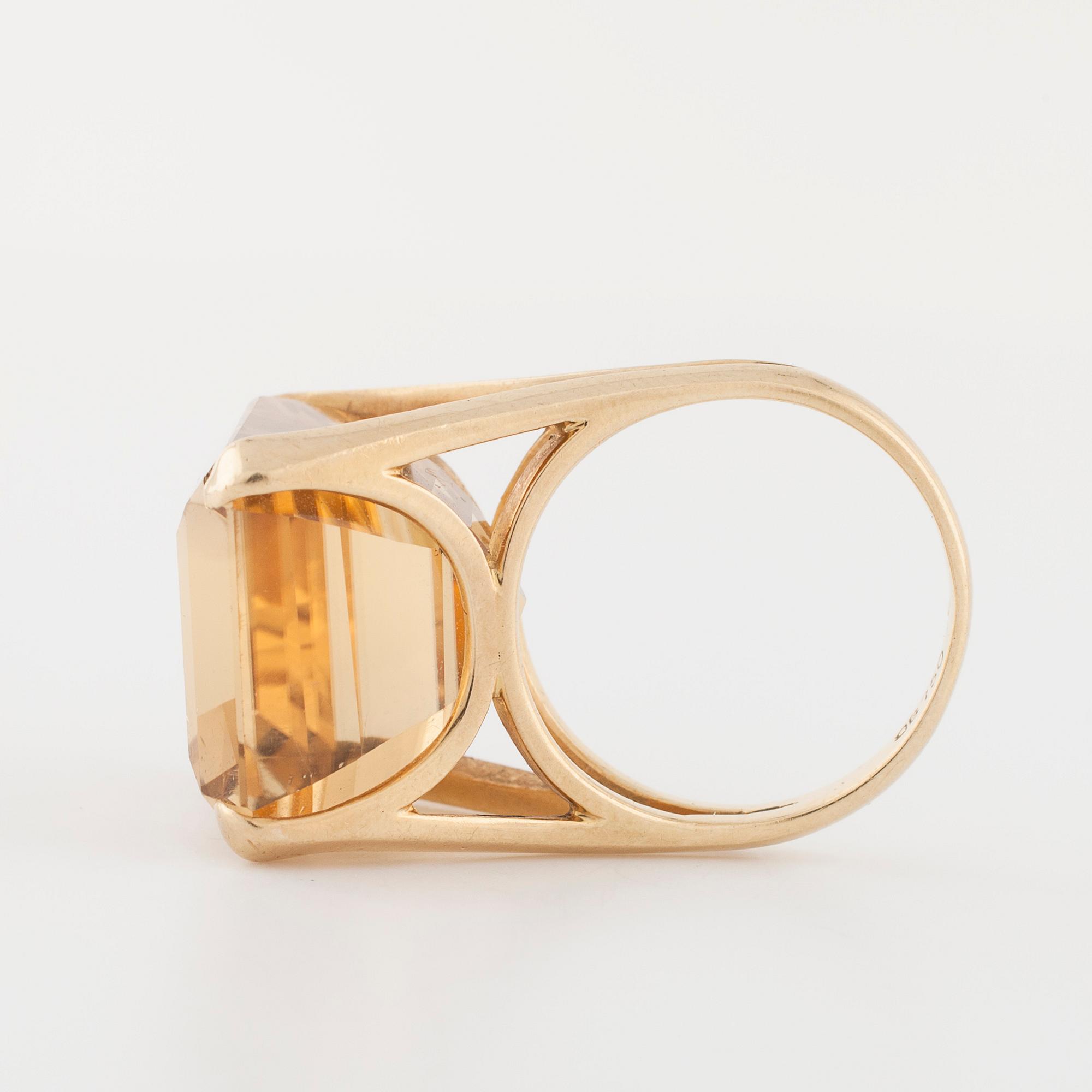 An emerald cut citrin ring.