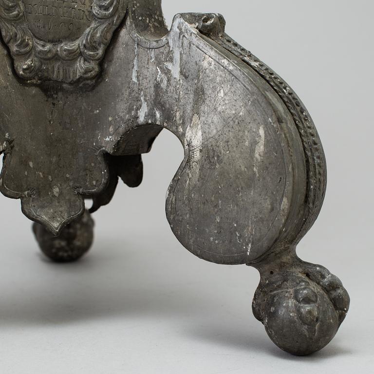 A pair of baroque pewter candlesticks, engraved date 1699.