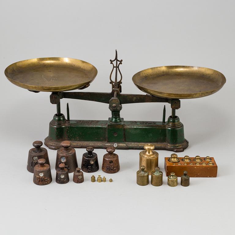 A 20th century cast iron balance with brass and iron weights, partly Skultuna, Sweden.