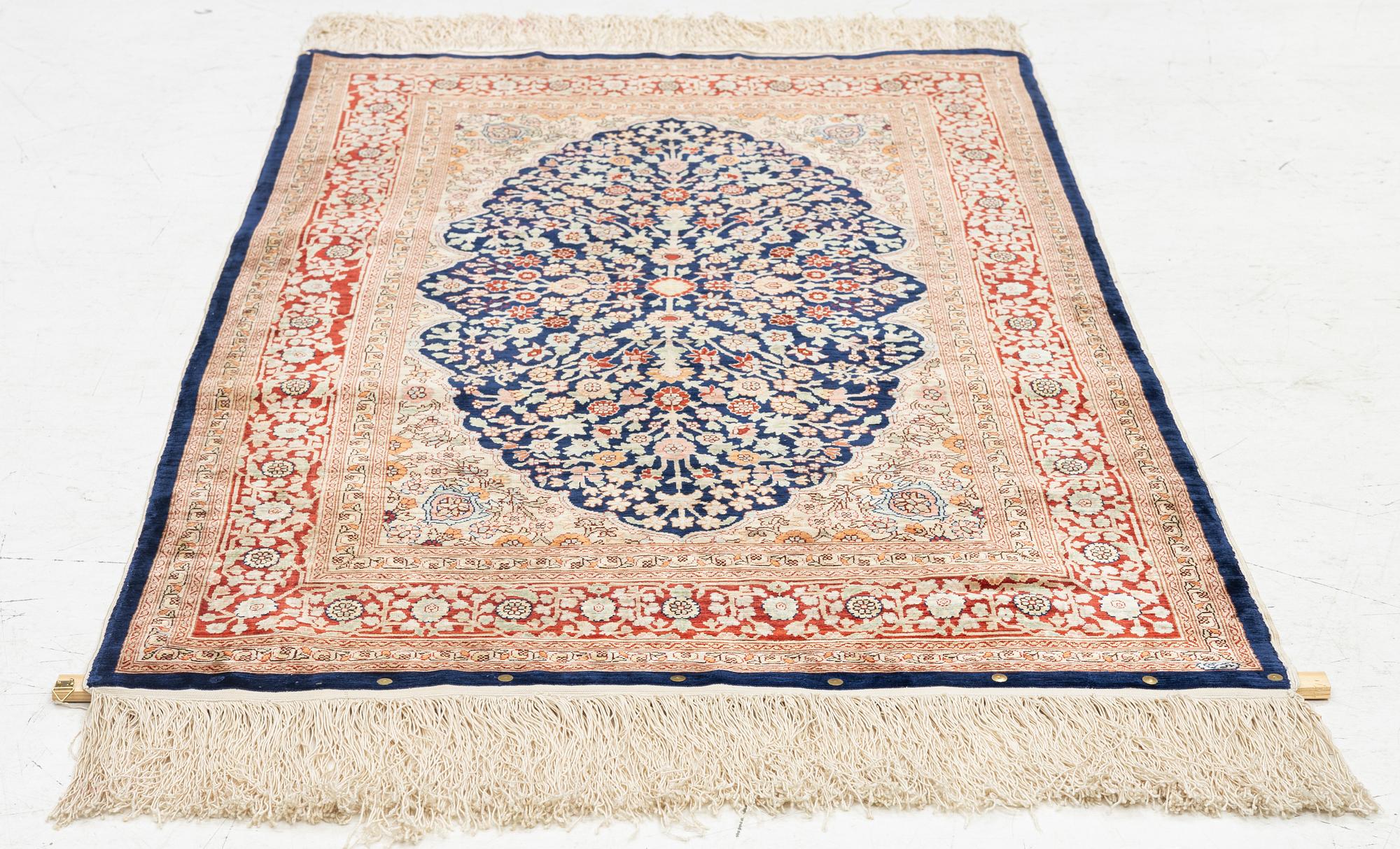 A Hereke silk rug, c. 130 x 71 cm.
