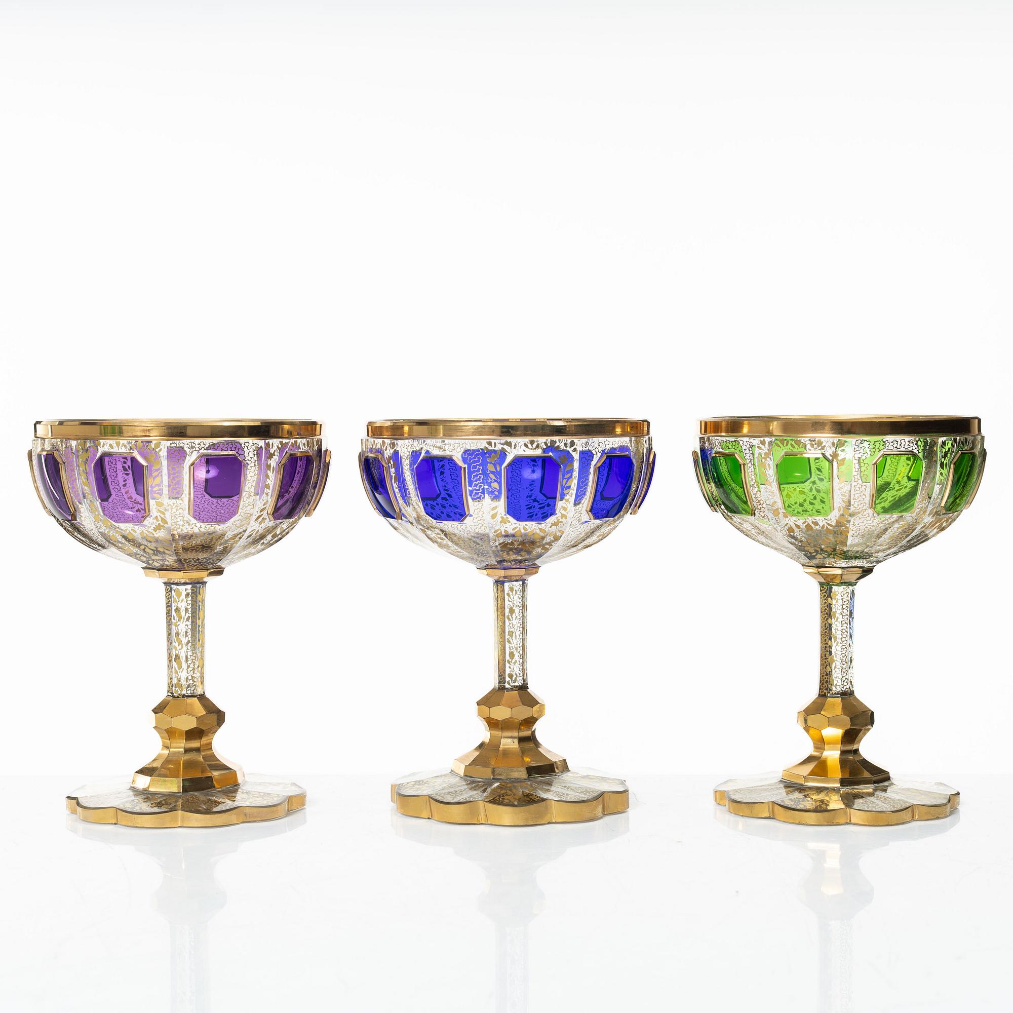A cut, gilded and coloured glass service, 20th century. (19 pieces).
