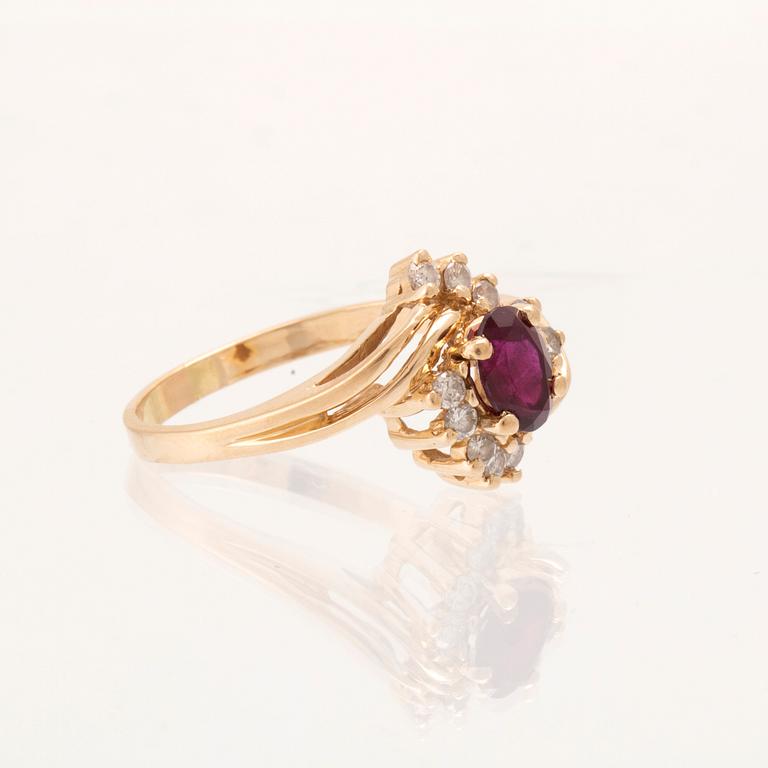 A 14K gold ring set with an oval faceted synthetic ruby and round brilliant-cut diamonds.