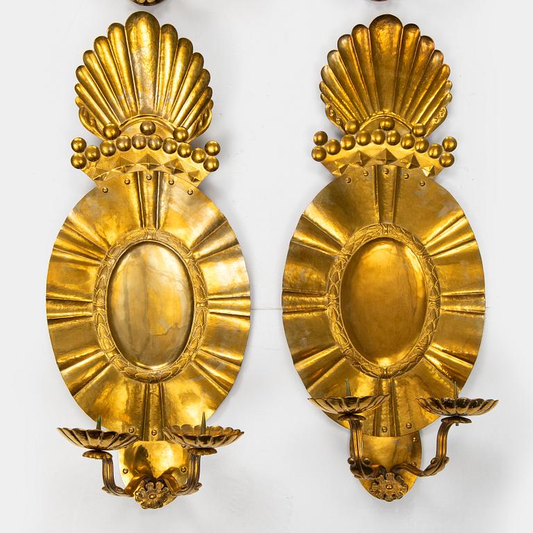 A set of four baroque style brass wall sconces, probably 1950s.