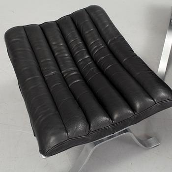 A black leather "Ari" easy chair with foot stool by Arne Norell for Norell möbler.