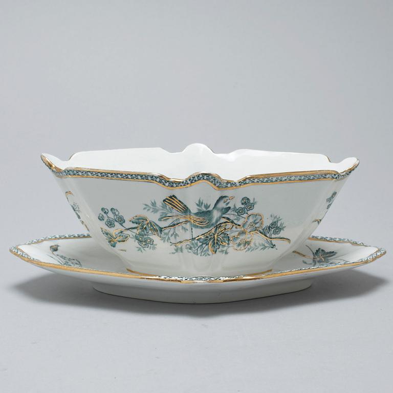A earthenware table set of 136 pcs "Vexiö Guld",  by Arvid Ekberg, Gustafsberg, from around year 1900.