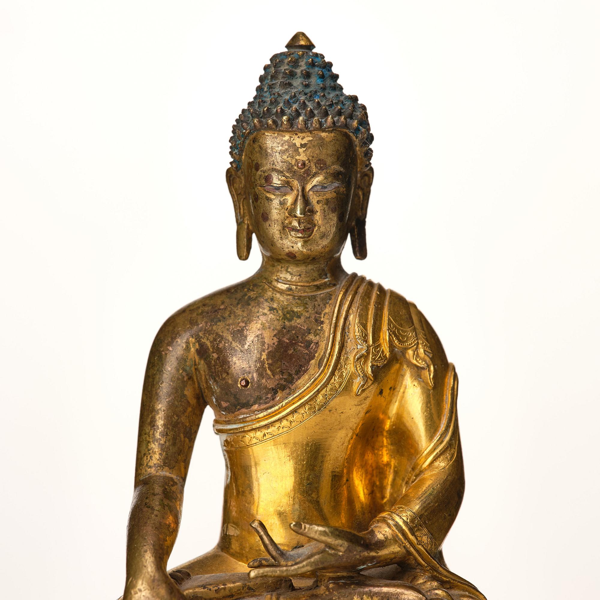 A Tibeto Chinese style gilt copper alloy figure of Buddha.