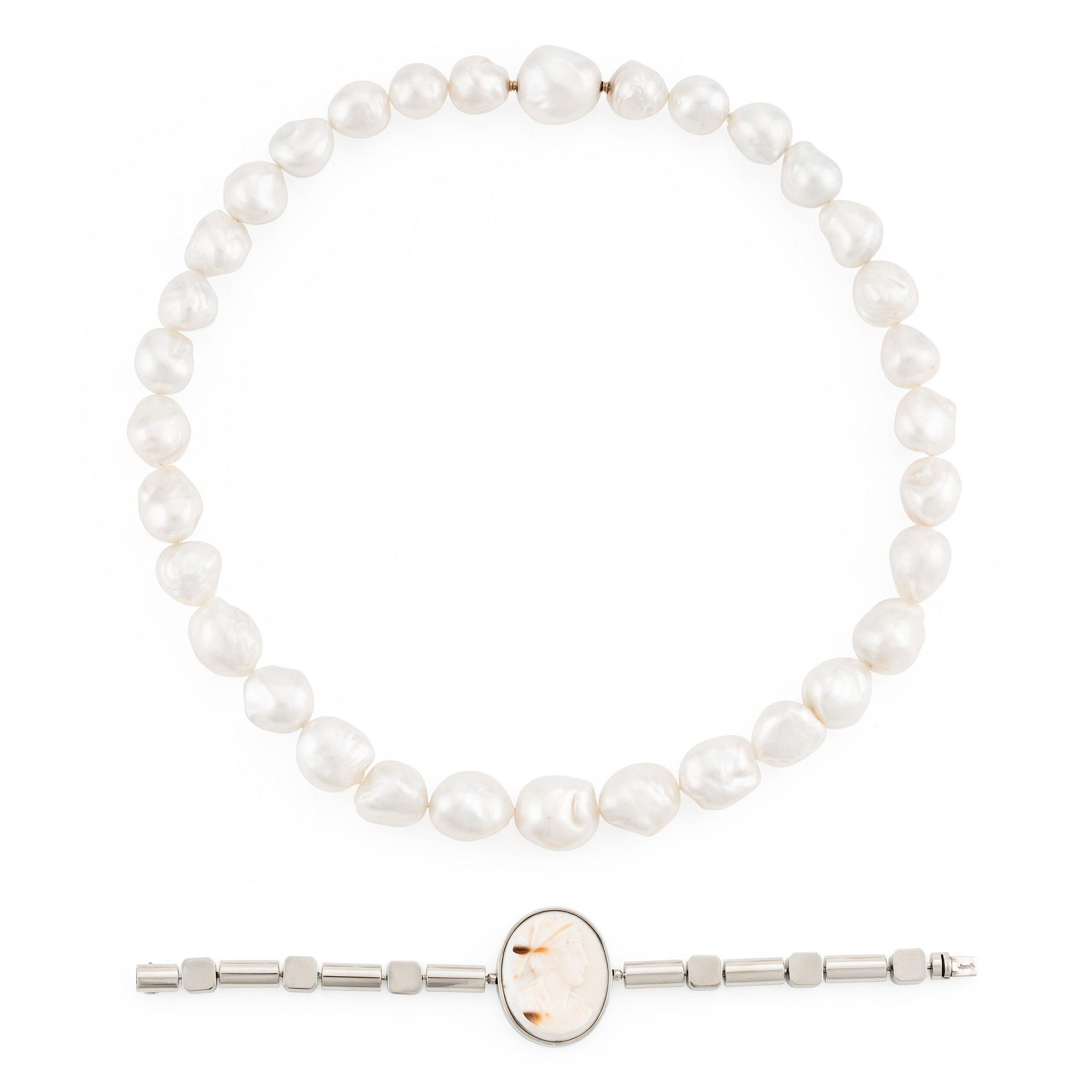 A Gaudy necklace with cultured South Sea pearls, a platinum bracelet, and two clasps.