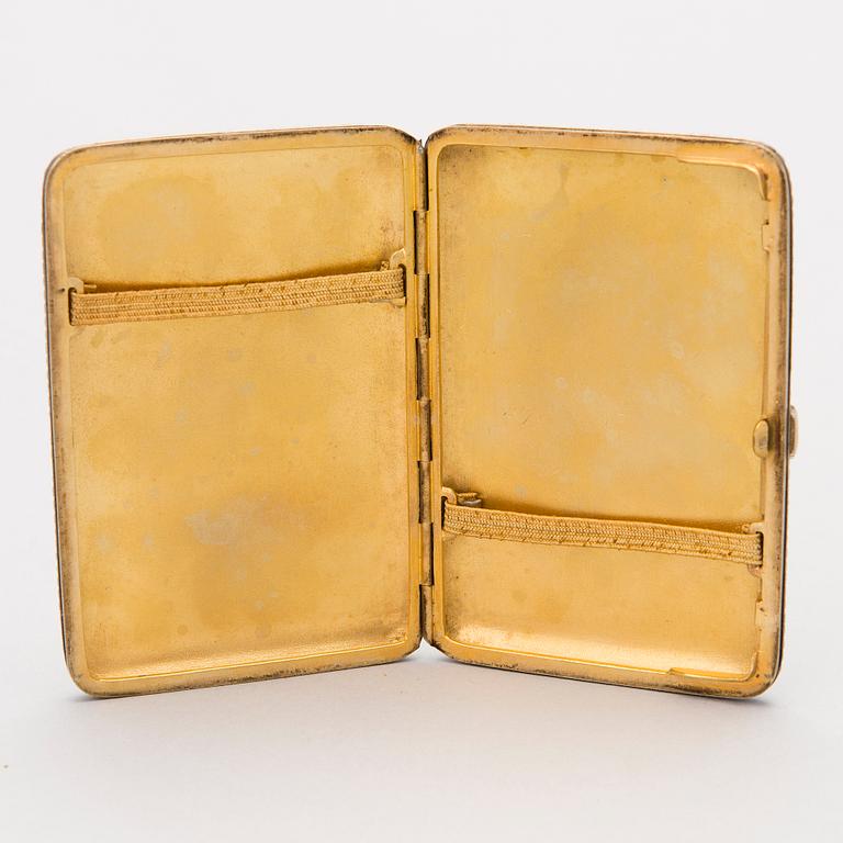 A Russian enamelled parcel-gilt cigarette case by Nikolai Zverev, Moscow 1908-1917.