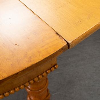 A mid 19th century birch dining table.