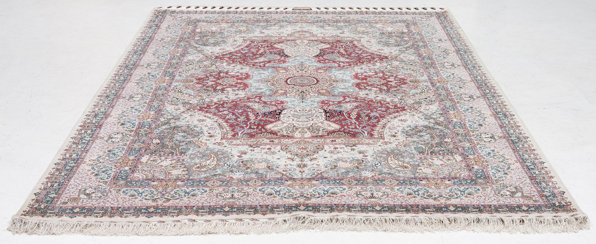 A Tabriz carpet, 210 x 195 cm. signed.