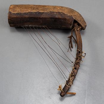 A STRING INSTRUMENT, wood, leather and rope, Africa first half of the 20th century, length 39,5 cm.