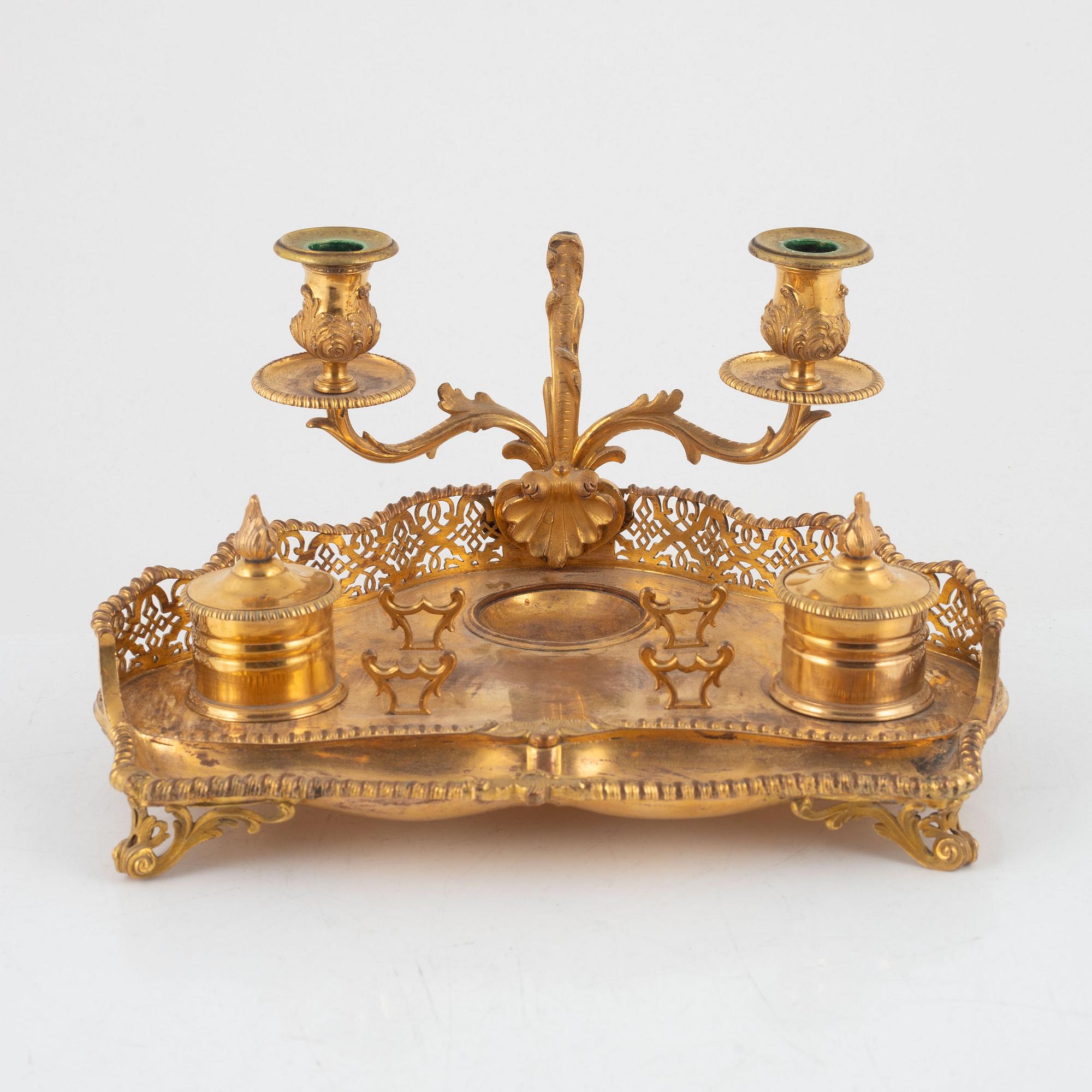 A gilt inkwell and candle holder, around 1900.