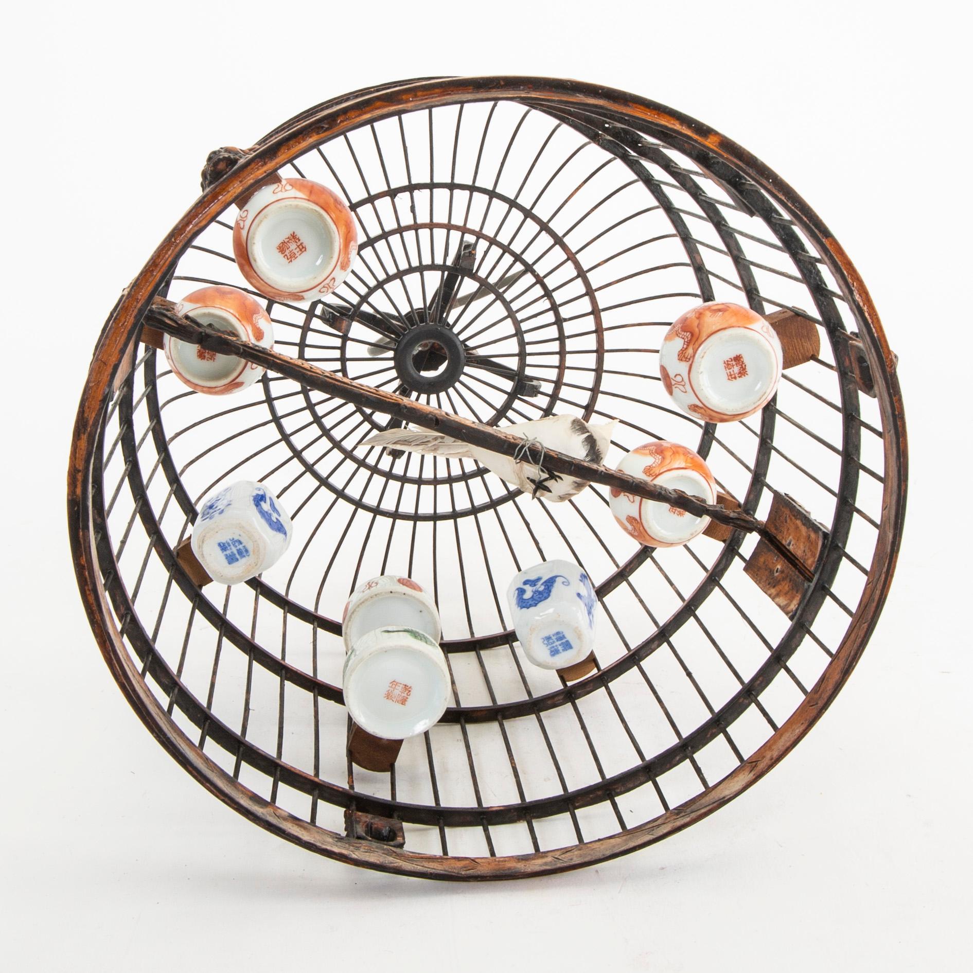 A Chinese bird cage with bird feeders, 20th Century.