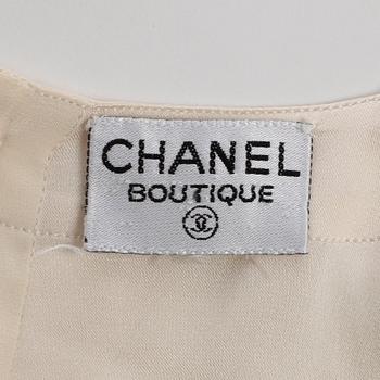 CHANEL, a white silk shirt.