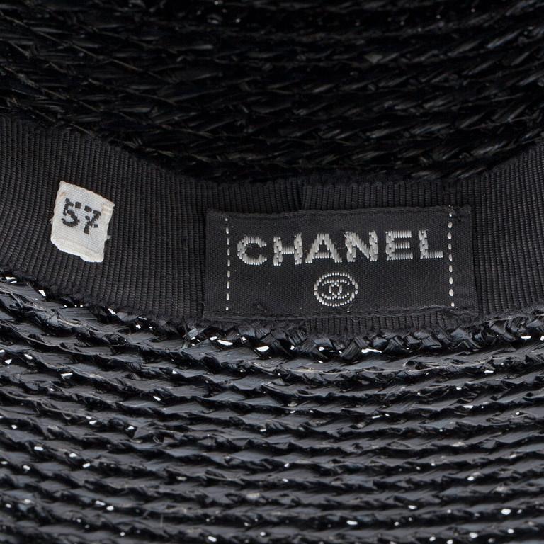 CHANEL, a black straw hat.