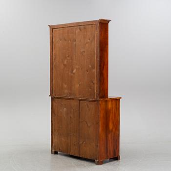 A mahogany veneered Empire cupboard, first half of the 19th century.