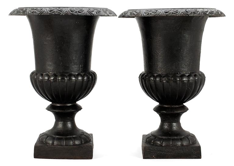 A pair of 20th cent cast iron garden urn.