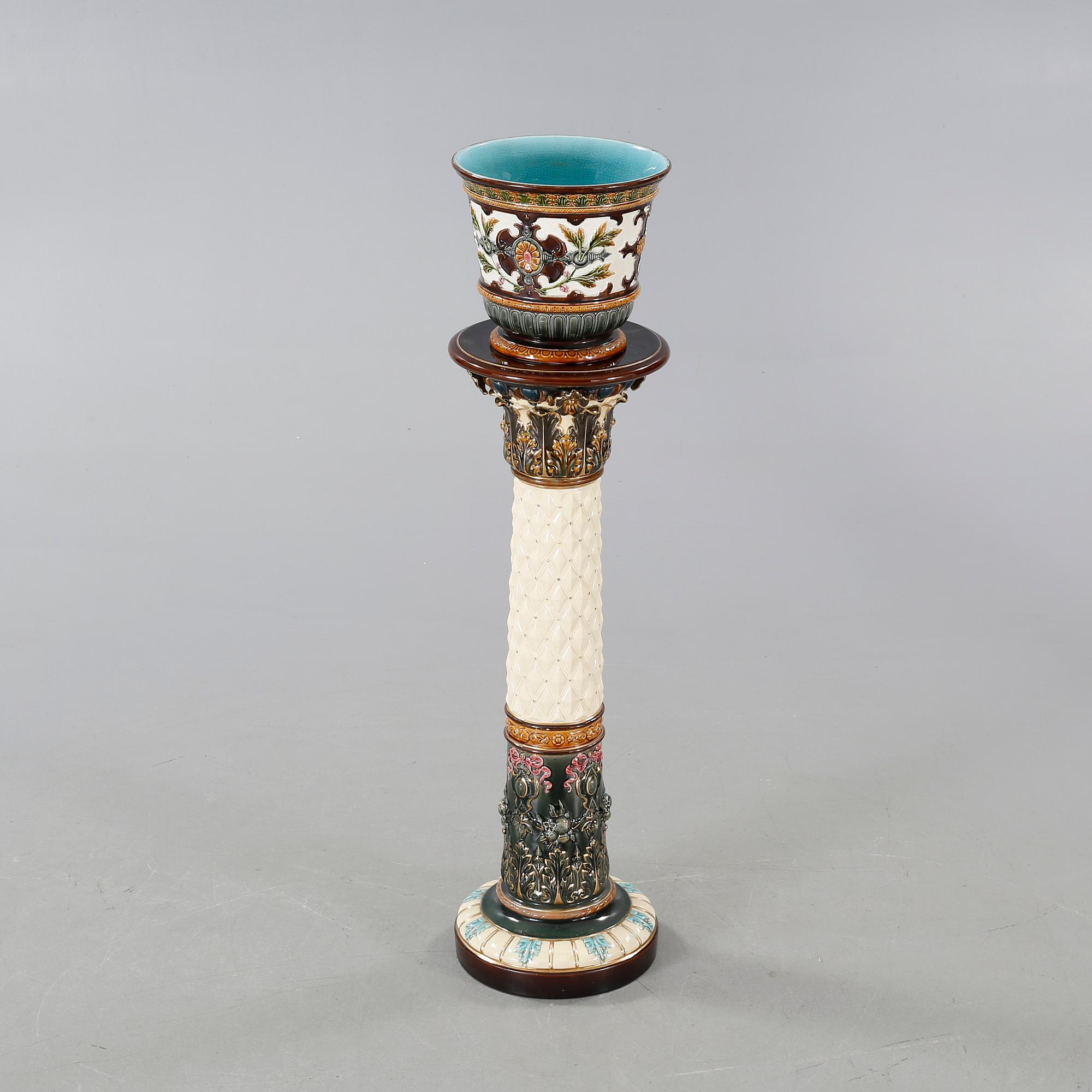 A Rörstrand pedestal with pot in majolica, made around year 1900.
