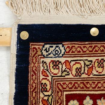 A Hereke silk rug, c. 130 x 71 cm.