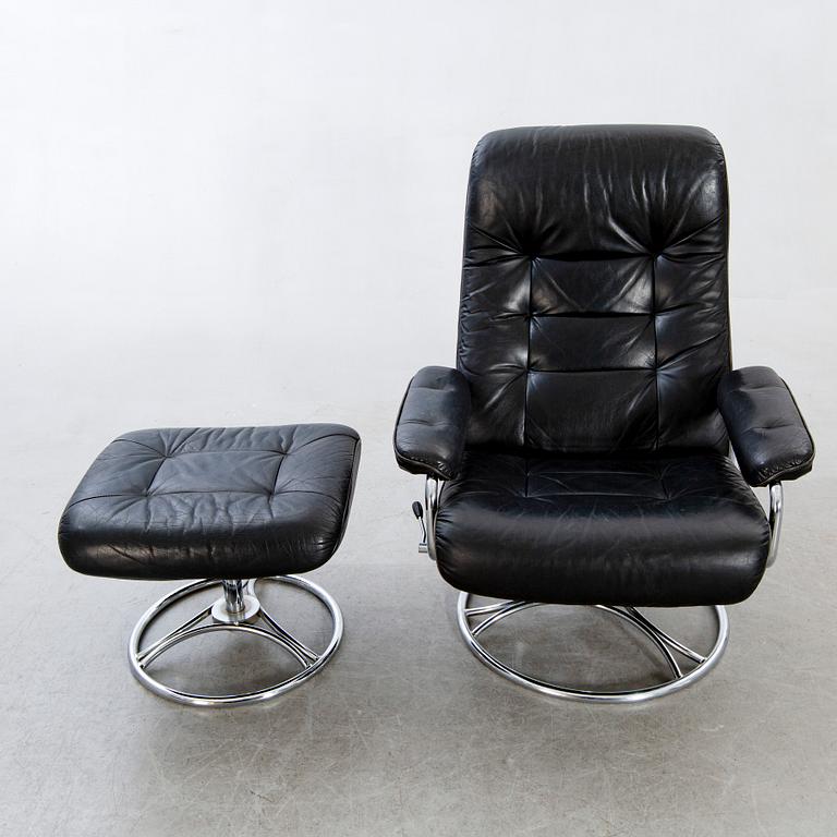 A leather swivel armchair and stool, Söderbergs  1980s.