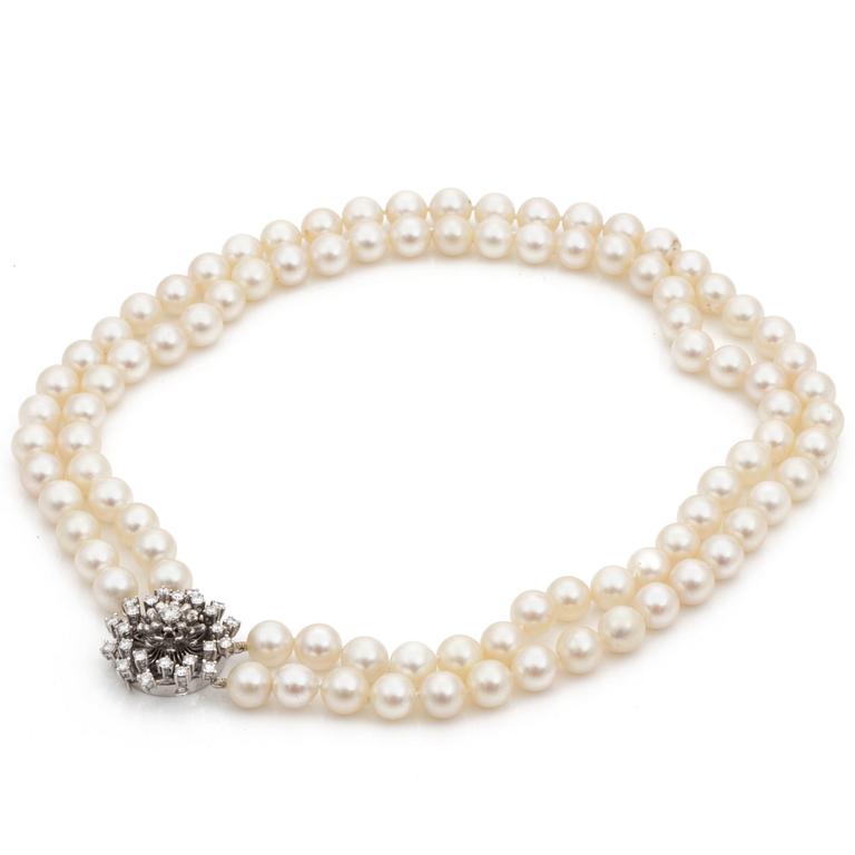 A two strand cultured saltwater pearl necklace. Pearls Ø 9 - 9,5 mm. Clasp set with diamonds.