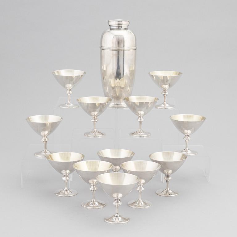 A silver plated shaker, C.G. Hallberg and a set of twelwe cocktail glasses, GAB, second half of the 20th Century.