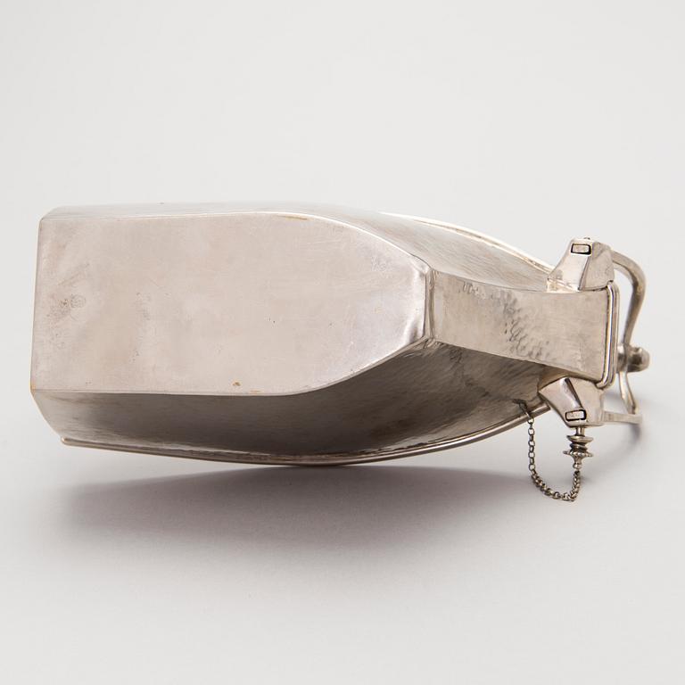 A metal wine bottle stand from WMF, Geislingen, Germany first half of the 20th Century.