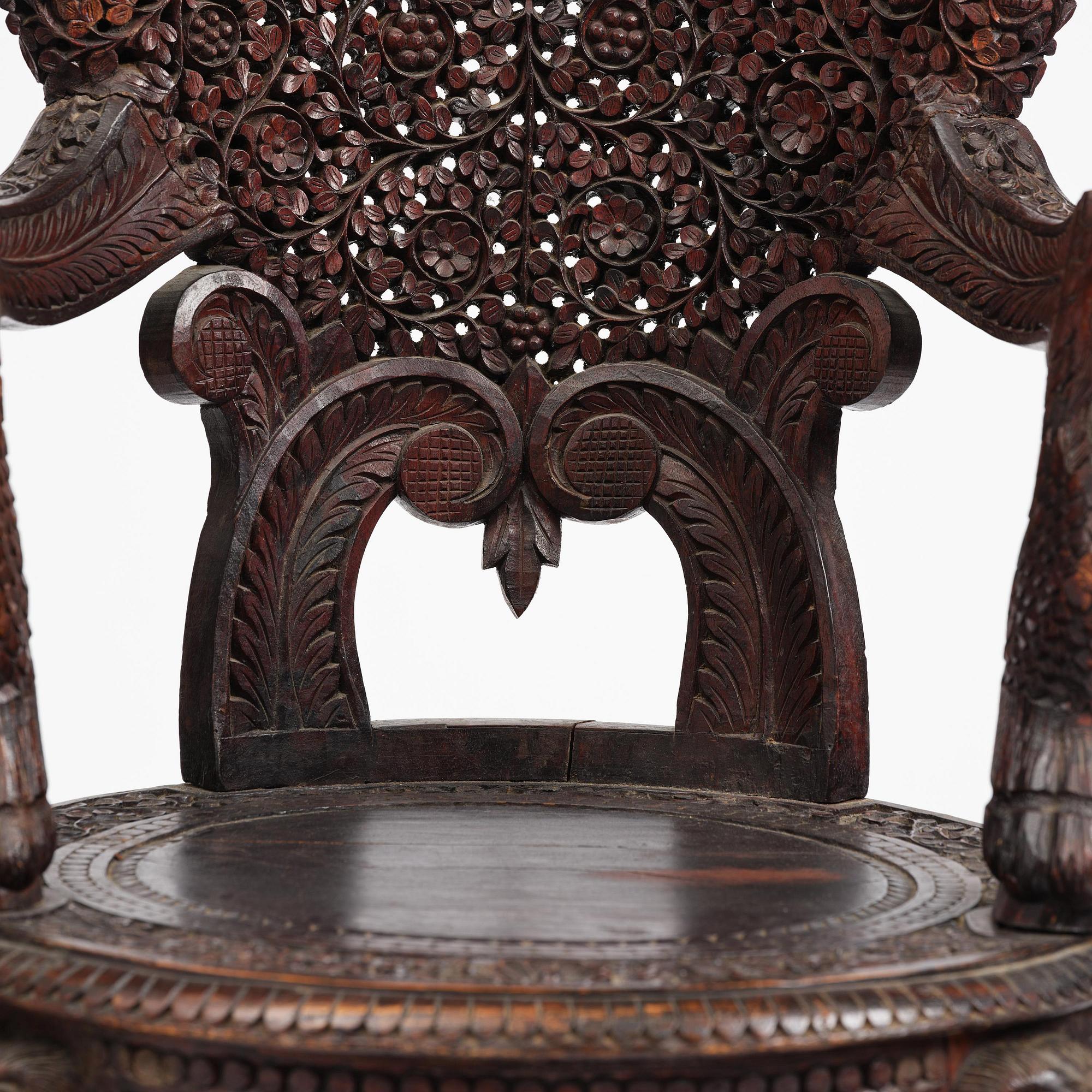 A pair of carved 'blackwood' armchairs, Bombay presidency, British Raj, circa 1880.