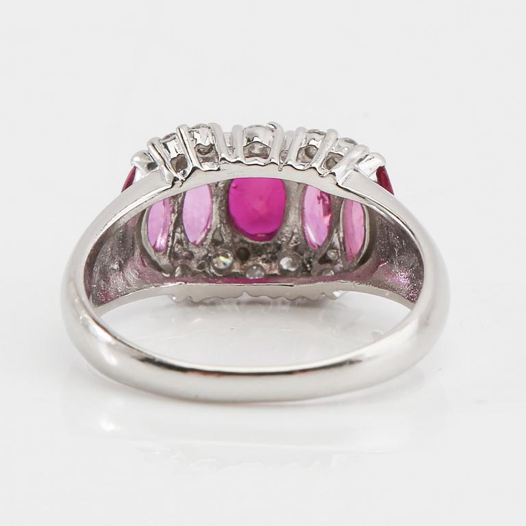 Ring in 850 platinum with navette-cut pink sapphires and round brilliant-cut diamonds.