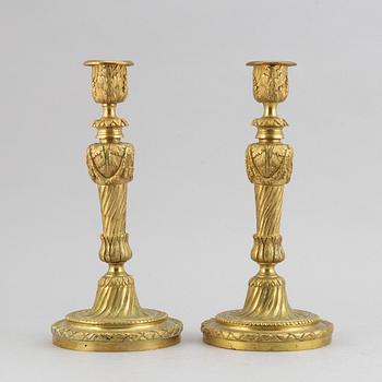 A pair of bronze Louis XV-style candlesticks, circa 1900.