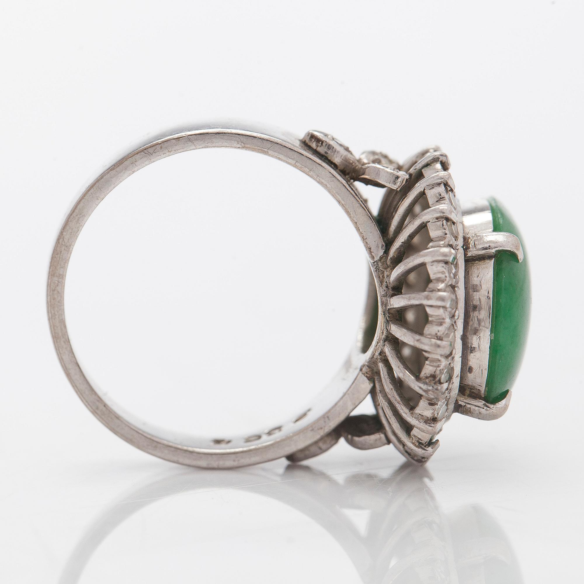 A palladium-plated silver ring with cabochon-cut jadeite and diamonds.