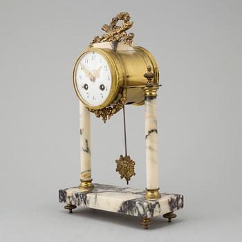 A marble and brass pendulum clock, first half of the 20th century.
