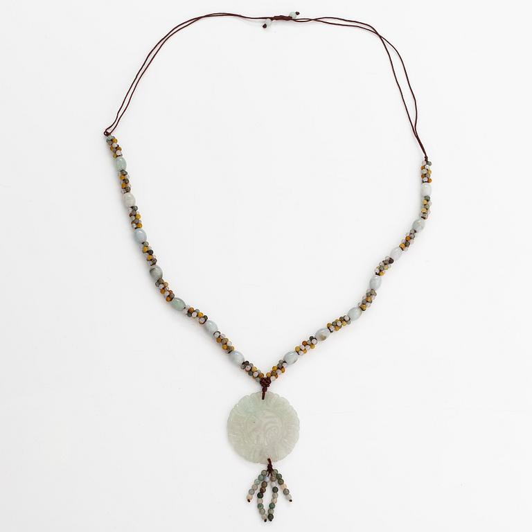 A collier with jade and nyon cord.