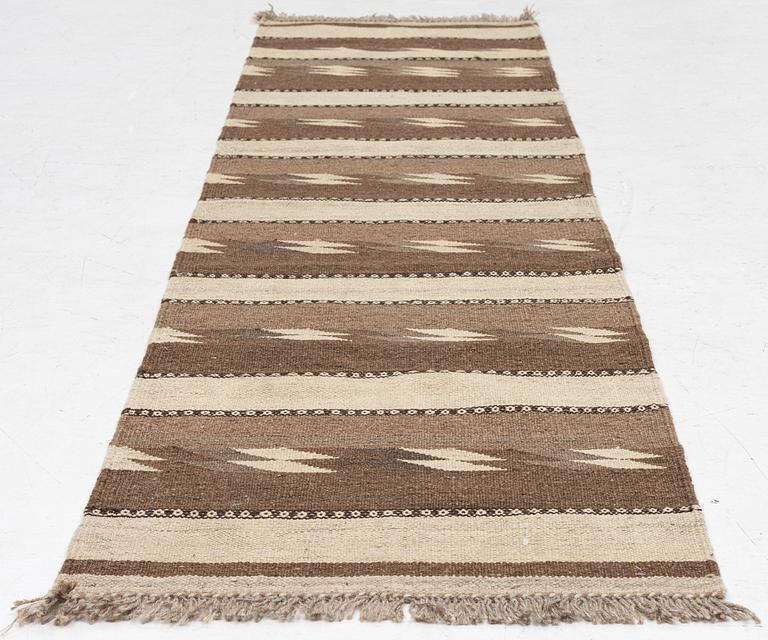 A Persian kilim runner, c. 248 x 62 cm.