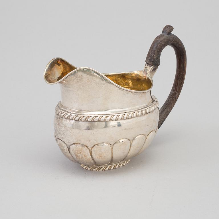 A Russian parcel-gilt cream jug, maker's mark Erik Frisk, St Petersburg, 1826.