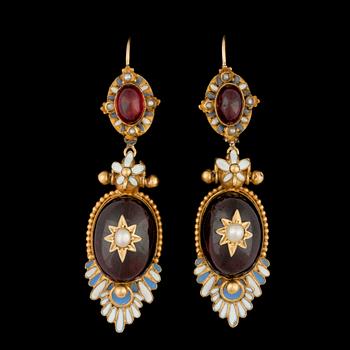 1303. A pair of cabochon cut garnet earrings.