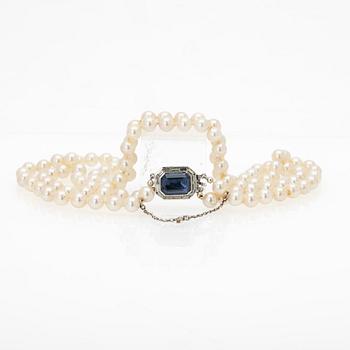 Two-row cultured pearl necklace with a silver and glass clasp.