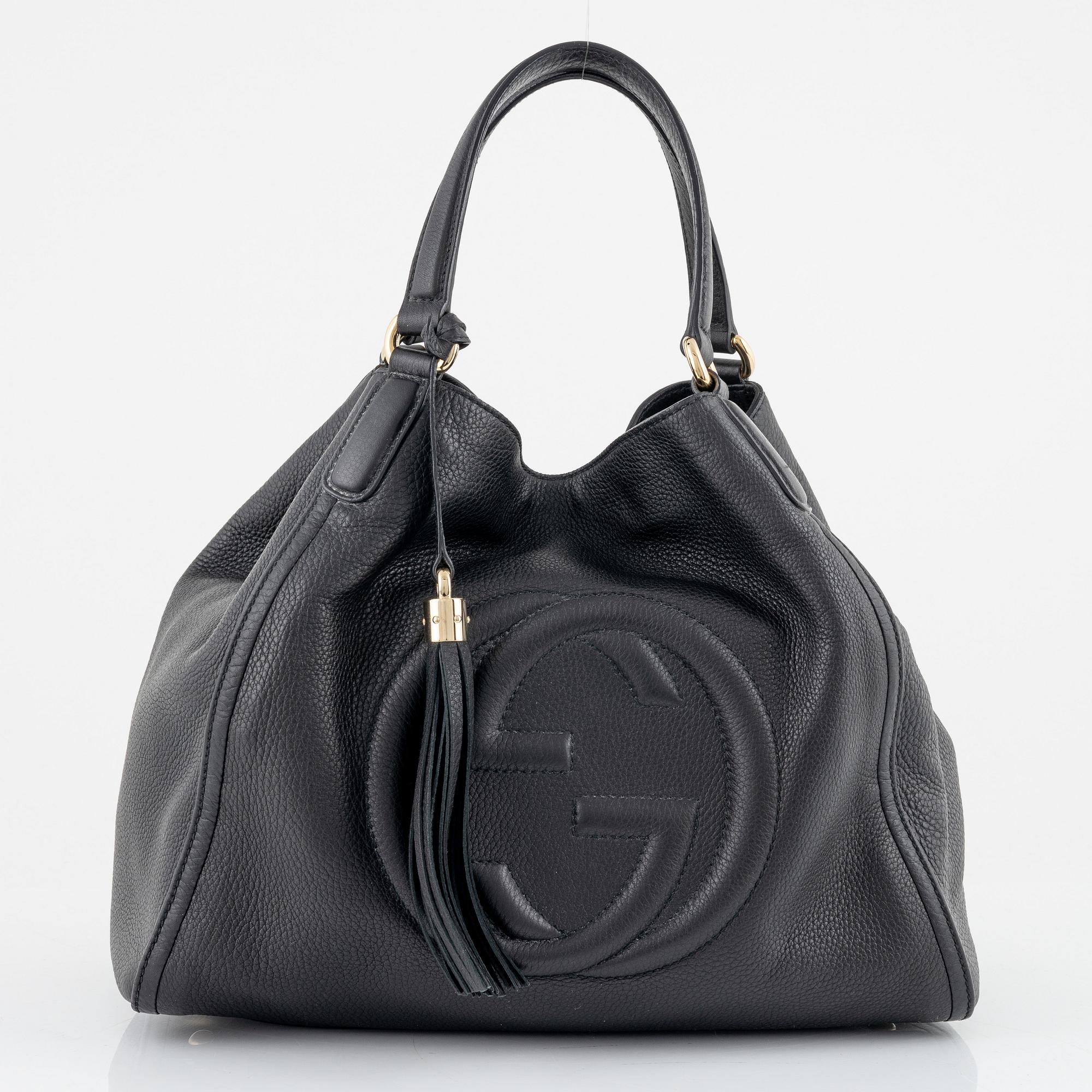 Gucci, a black leather handbag.