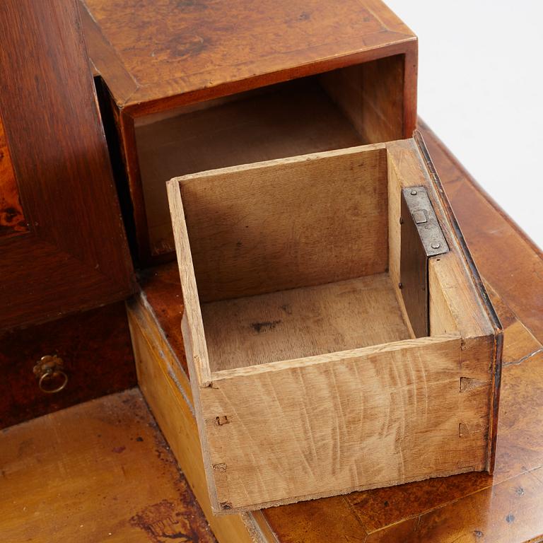 A Swedish late Baroque alder-veneered 'knee-hole' writing desk, first part of the 18th century.