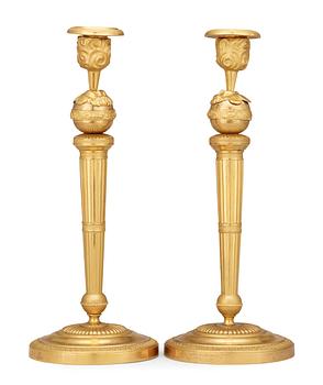 559. A pair of Empire early 19th century candlesticks.