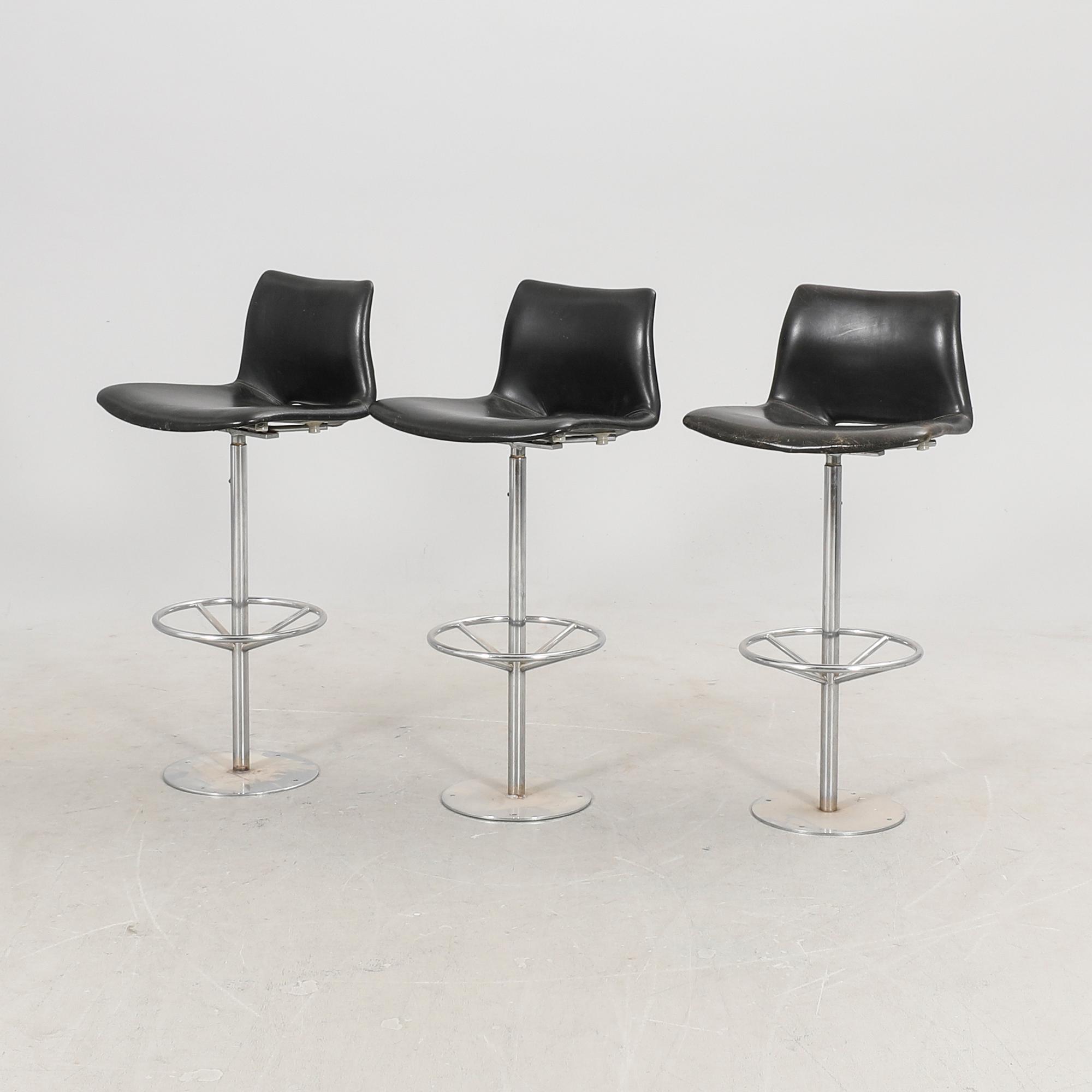 A set of three late 20th century metal and leather bar stools.