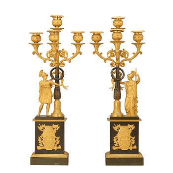 547. A pair of French Empire early 19th century gilt and patinated bronze four-light candelabra.
