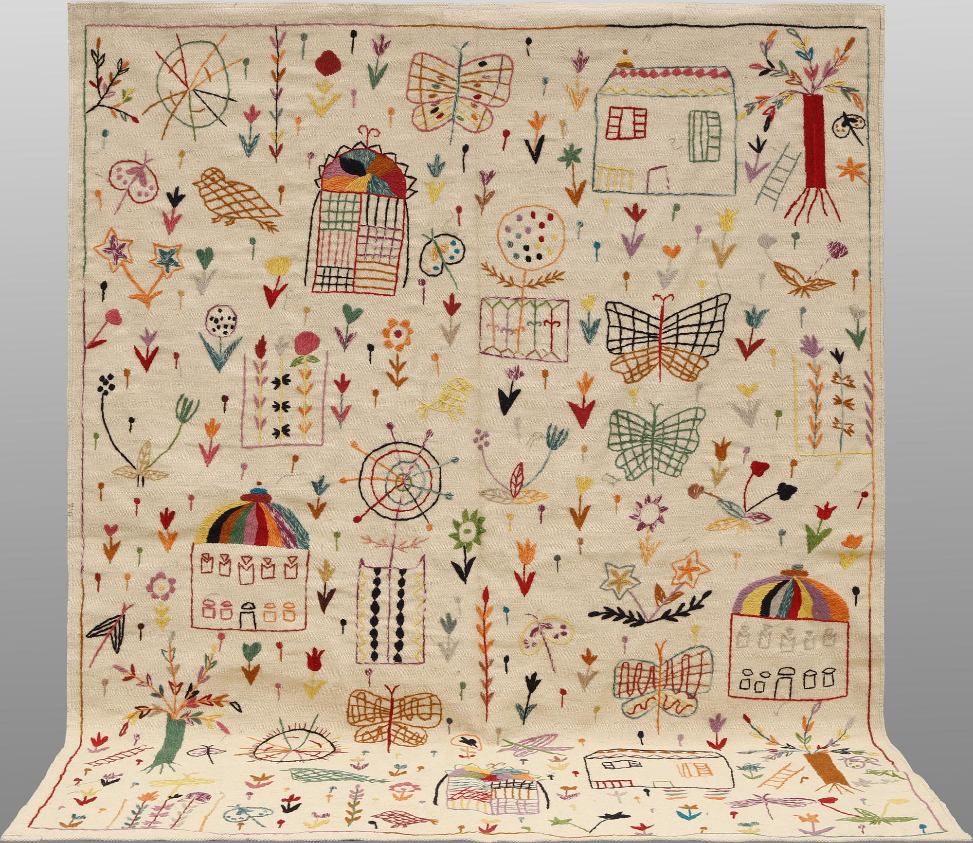 A hand-embroidered Kilim rug, approx. 240 x 181 cm.