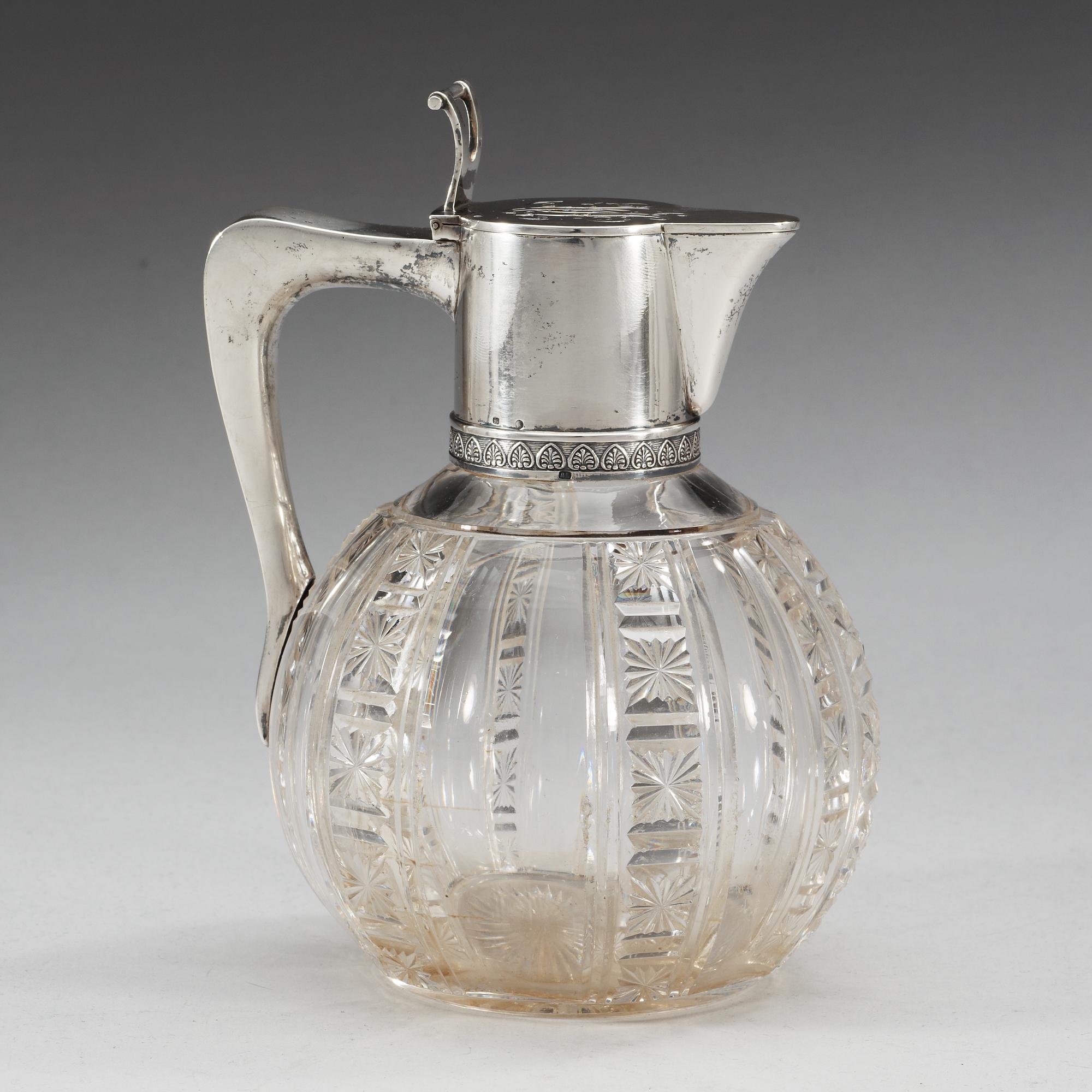 A Russian early 20th century glass and parcel-gilt jug, makers mark of the firm Morozov, (S:t Petersburg).