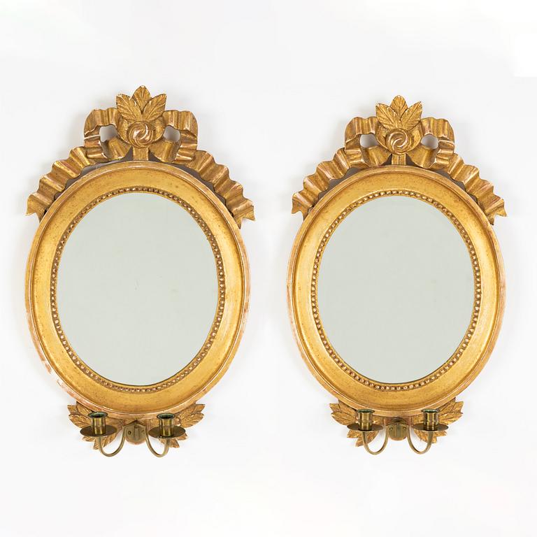 A pair of Gustavian style two-light giltwood girandole mirrors, 20th century.
