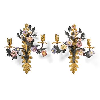 96. A pair of French Louis XV-style gilt bronze and porcelain two-branch appliques, 19th century.